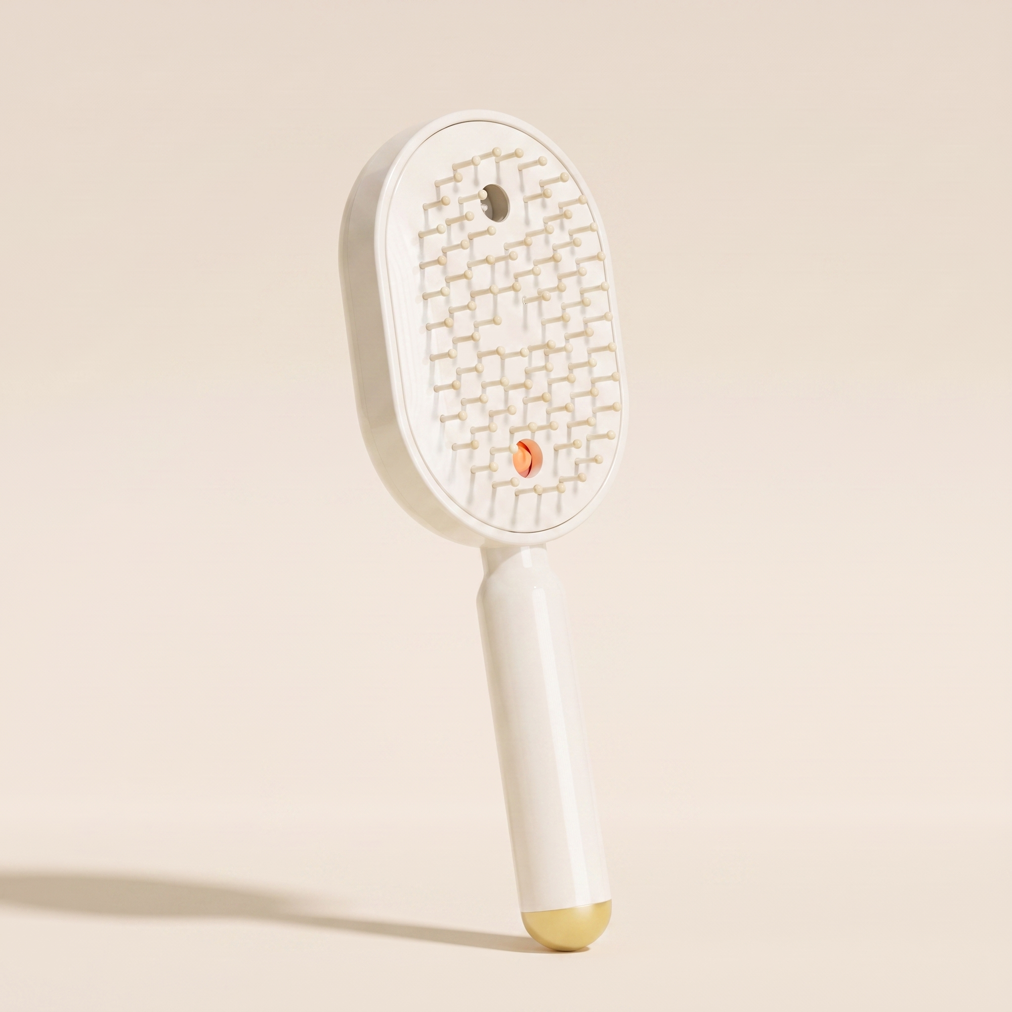 The Ivresse Mist and Glow Brush in beige, showing the cream bristles and champagne gold handle tip.