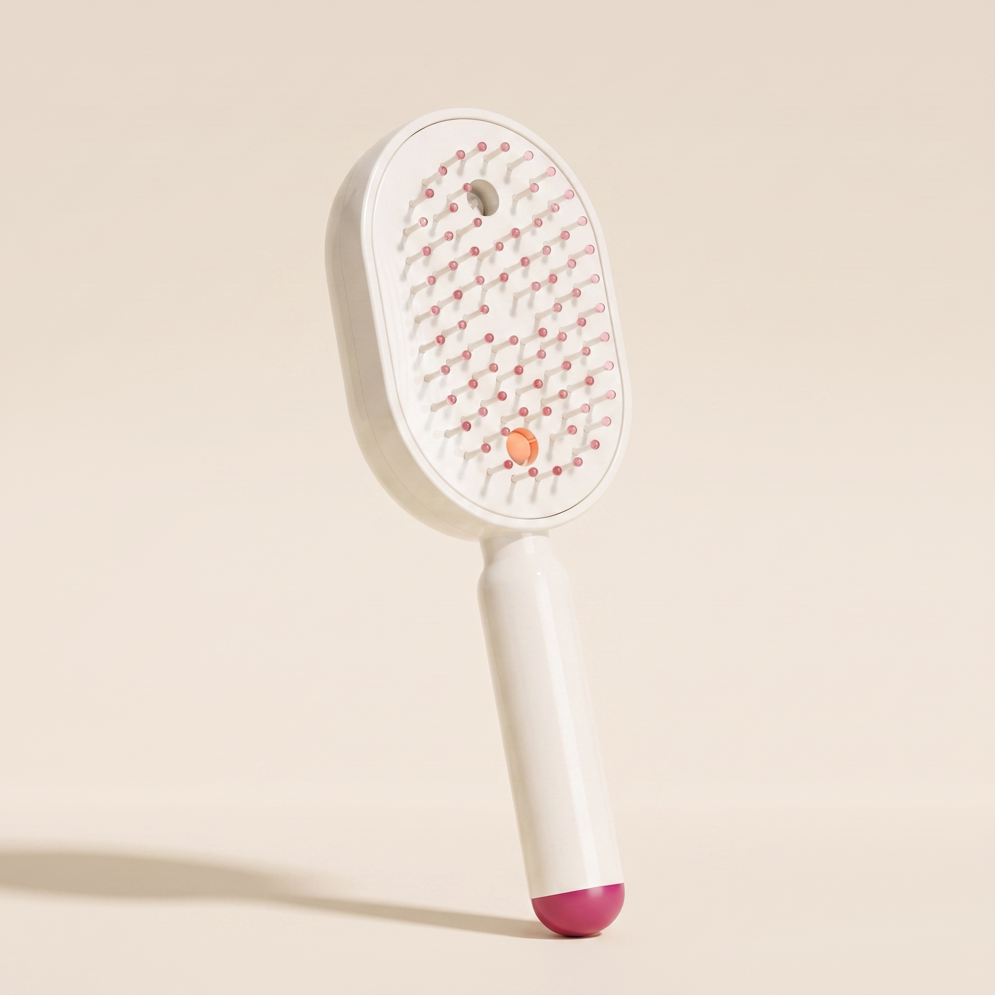 The Ivresse Mist and Glow Brush in pink, showing the rose bristle tips and magenta handle tip.